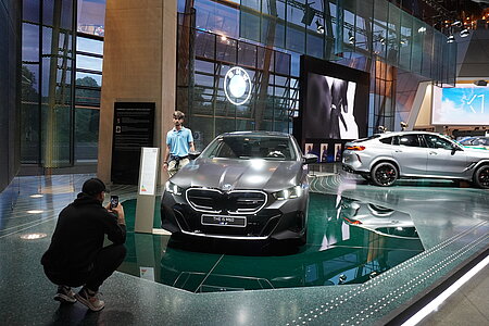 Students taking pictures at the BMW Welt in Munich.